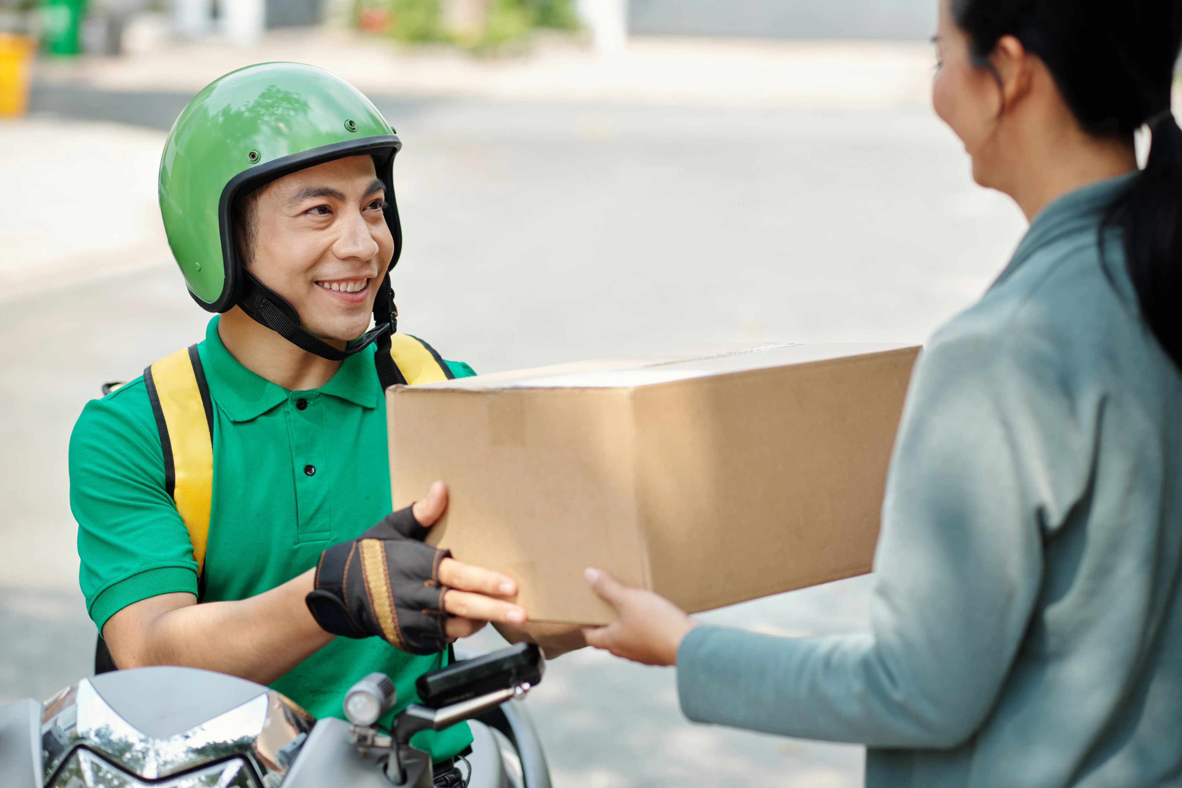 Delivery rider handing over a package