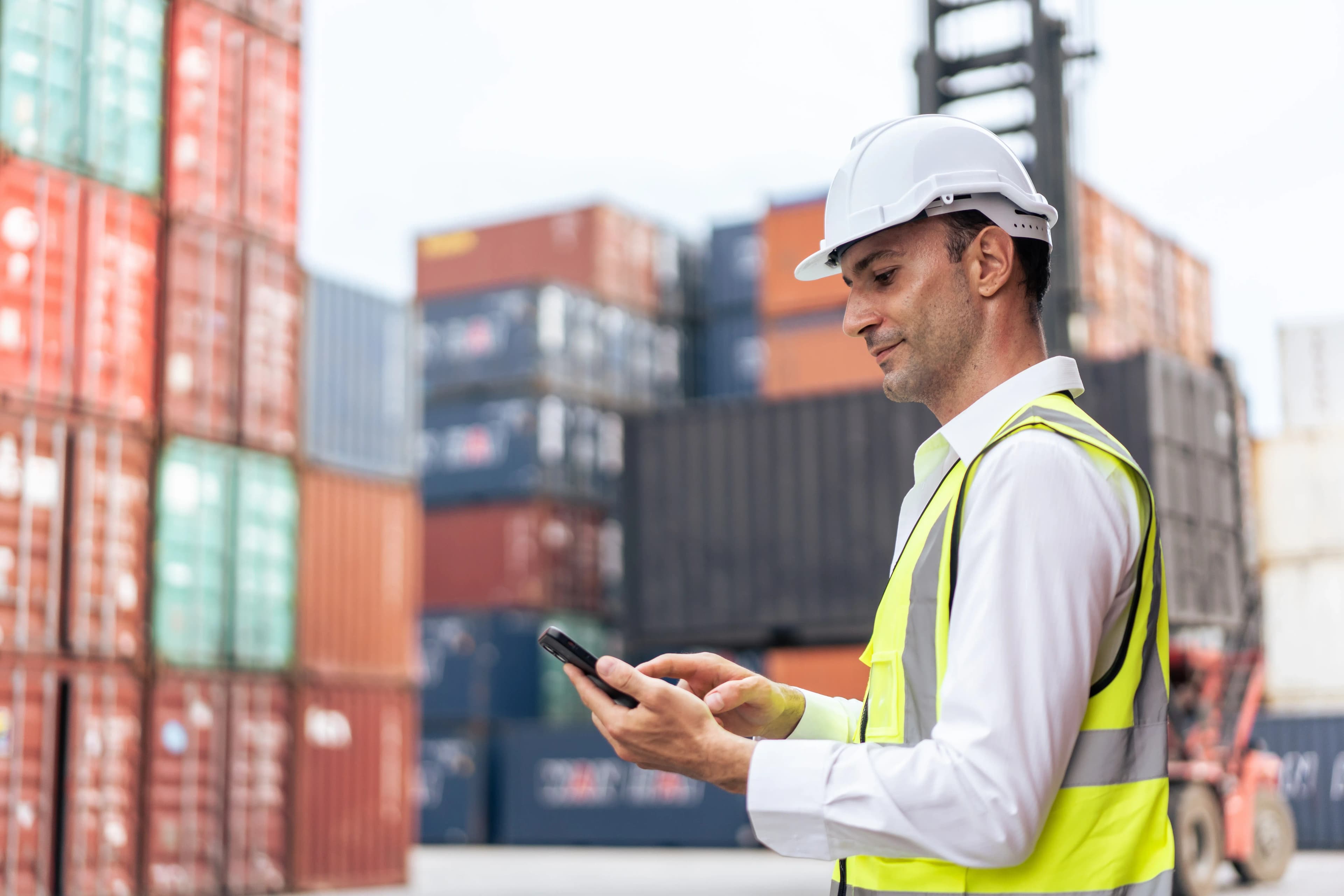 Worker tracking shipment at port